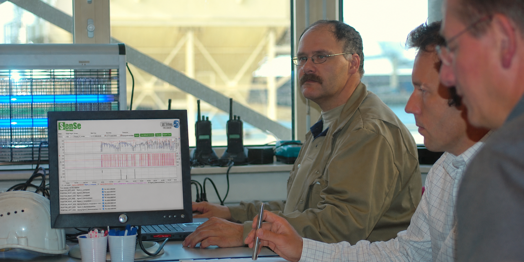 Engineers discussing process data displayed in SenSe