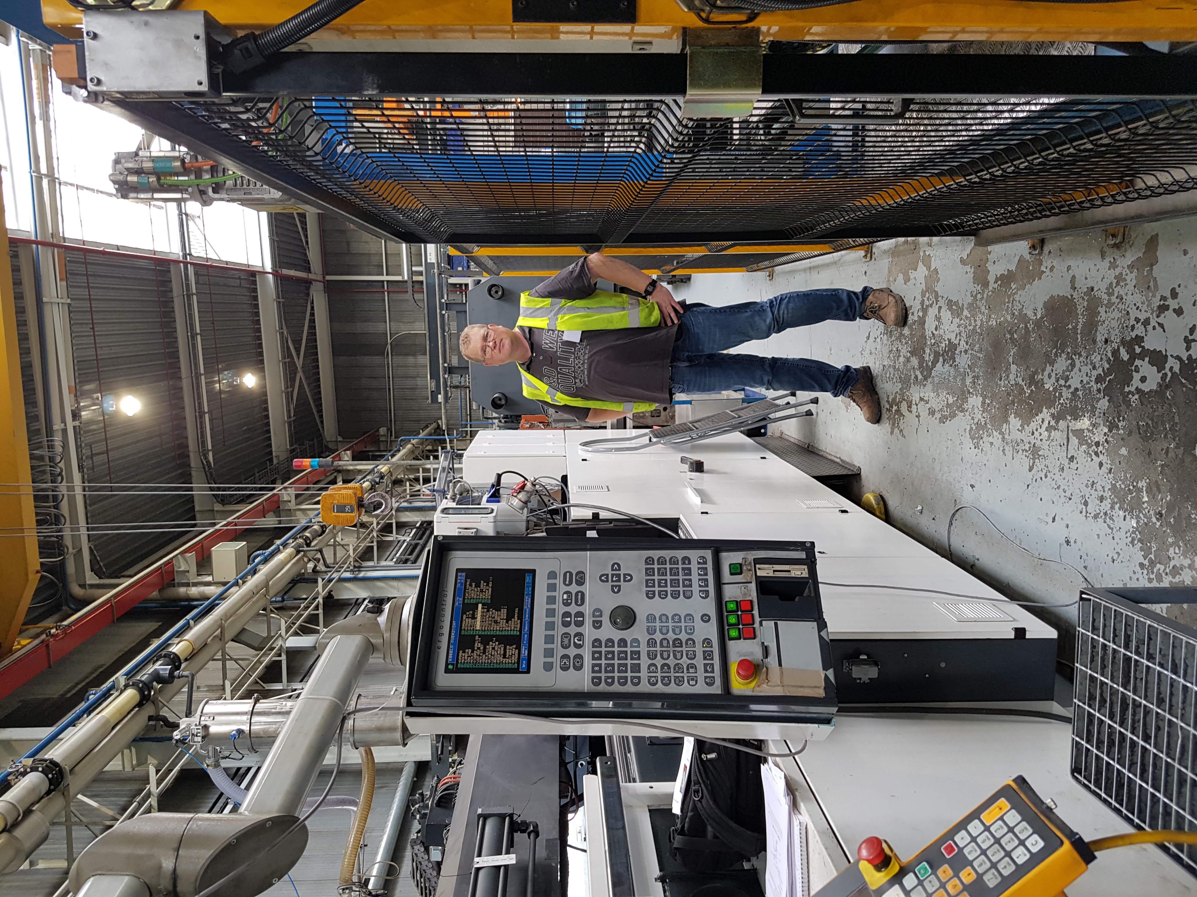 Engineer beside an industrial machine control